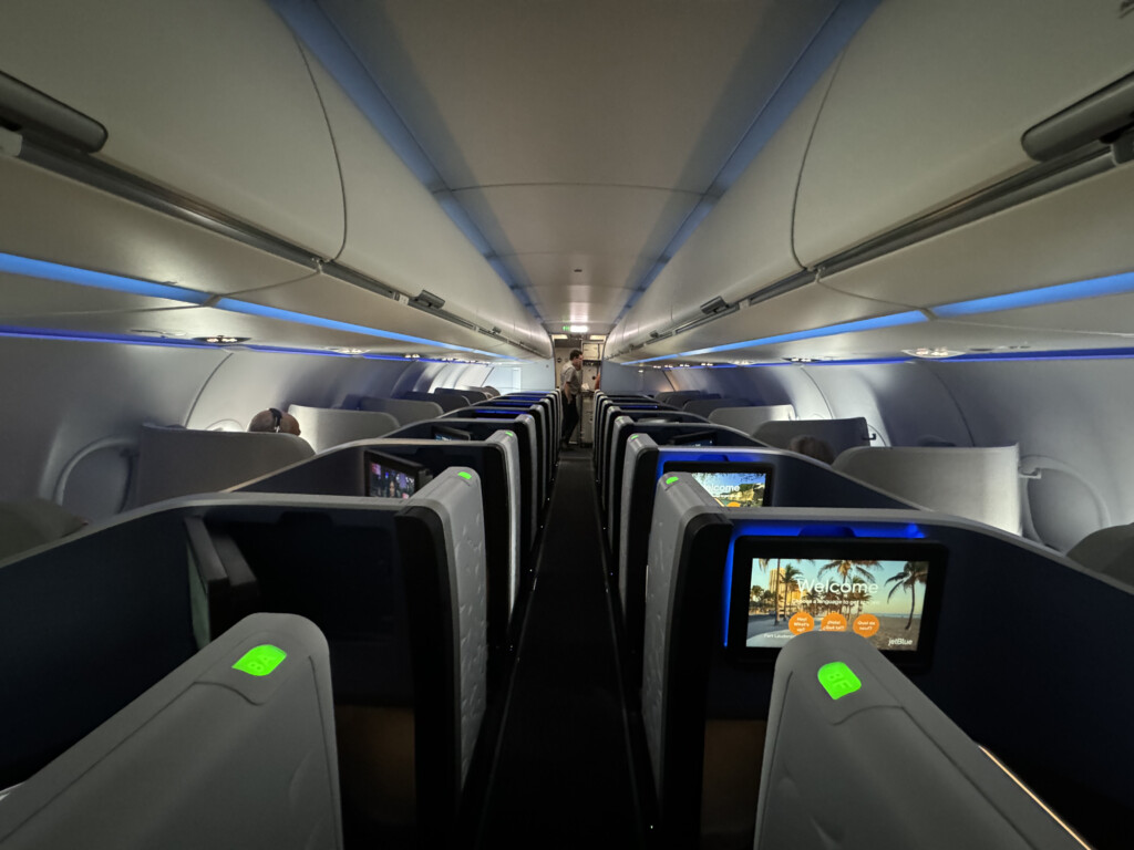 an airplane with seats and a person walking