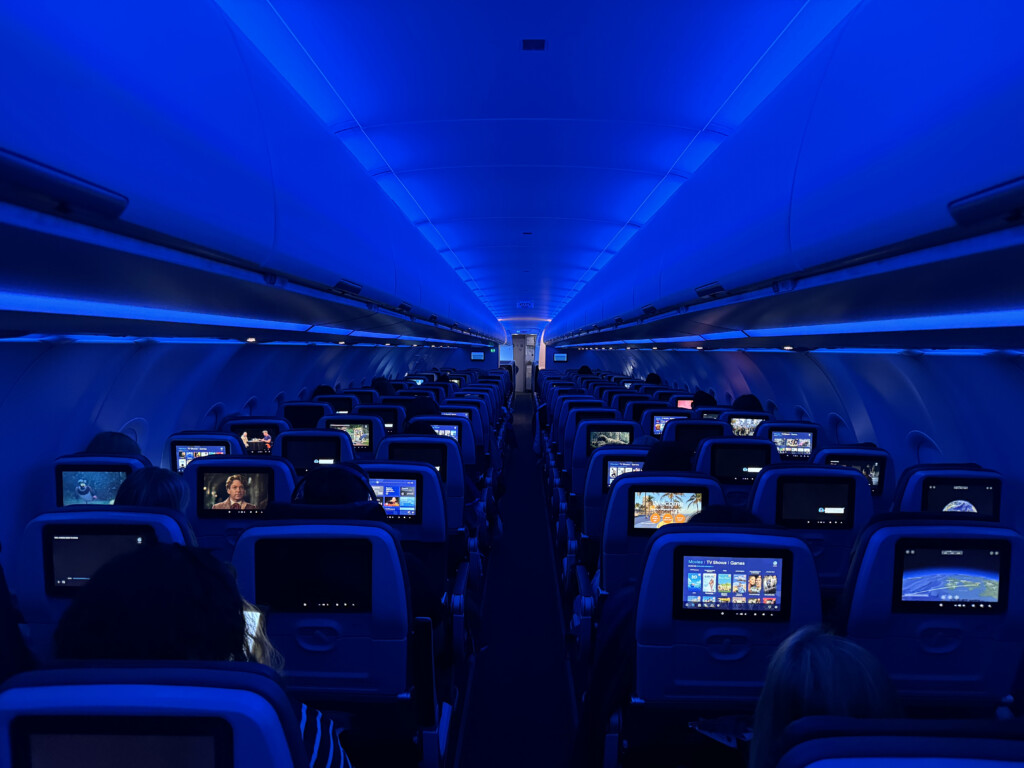 a row of seats with rows of seats with people sitting on them