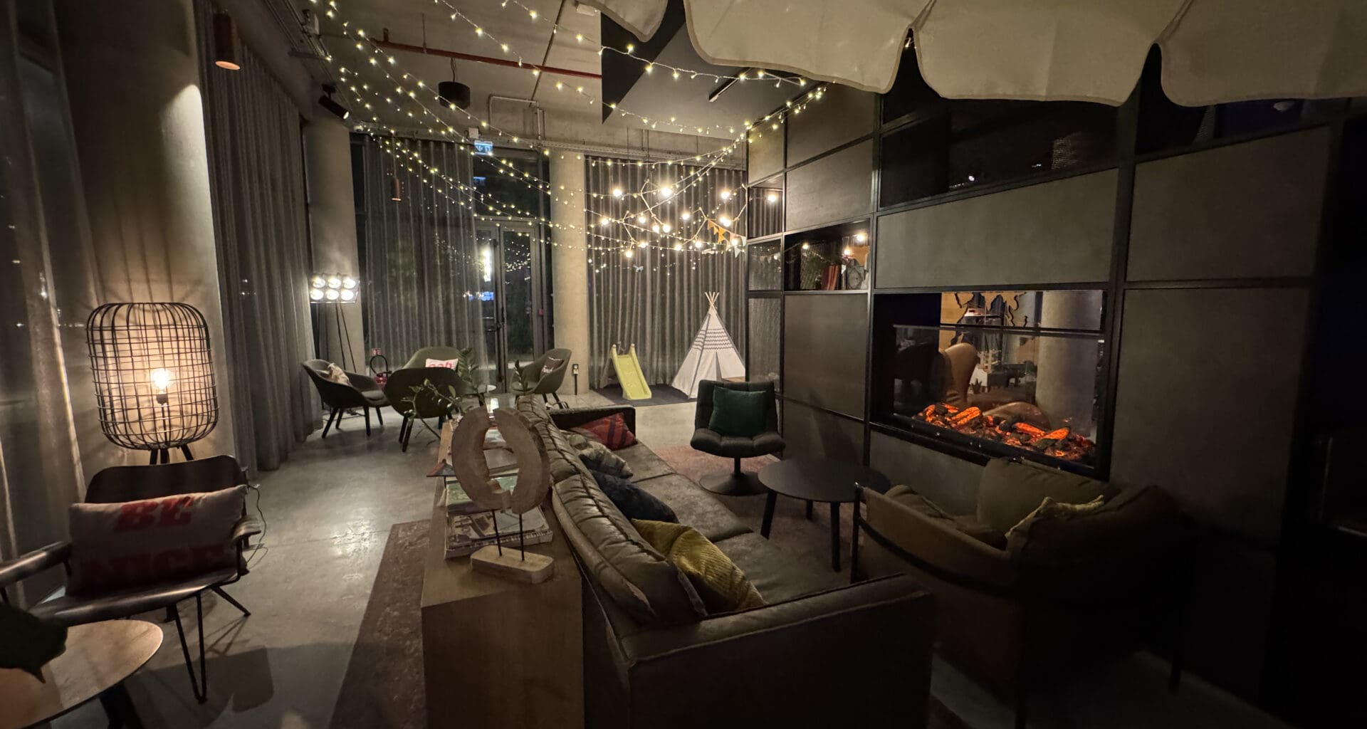 a room with a fireplace and lights