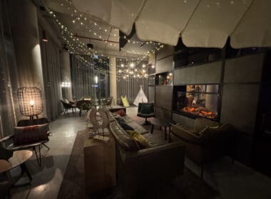 a room with a fireplace and lights