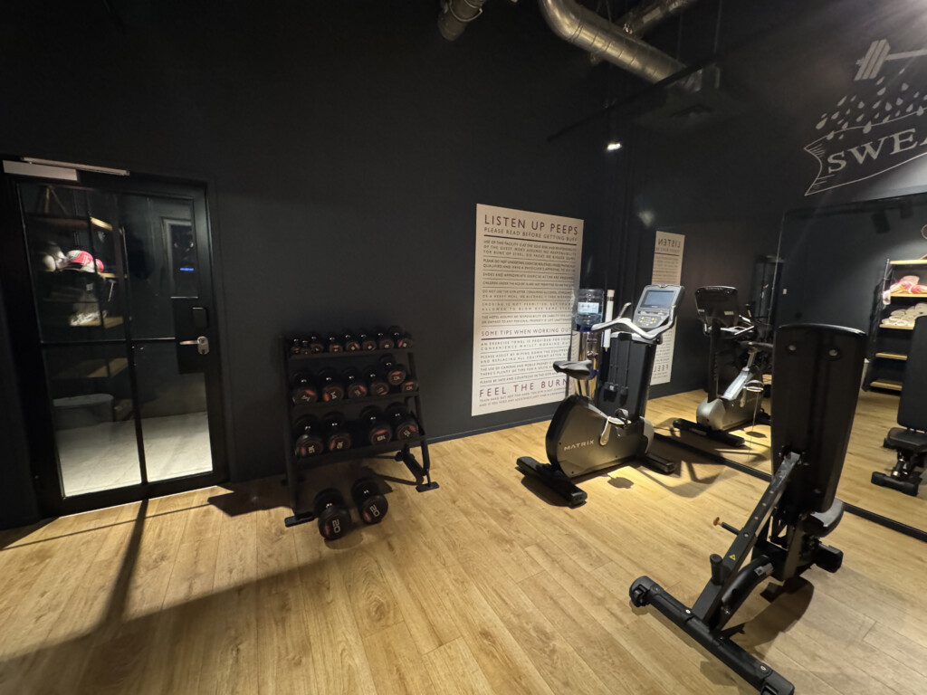 a room with exercise equipment and a door