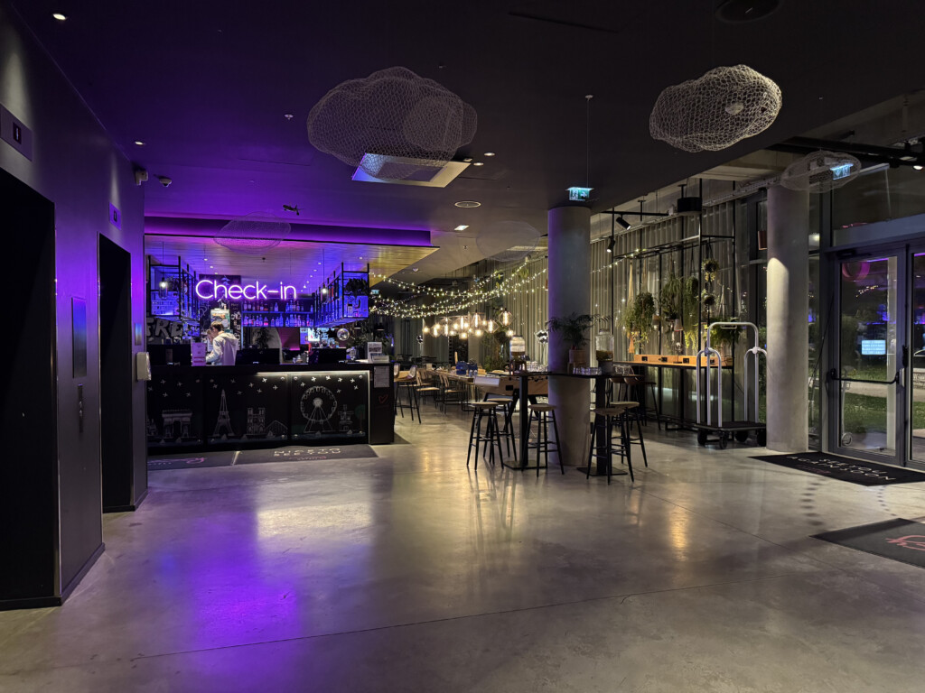 a room with a bar and purple lights