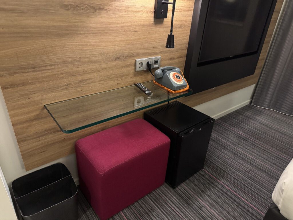 a glass shelf with a telephone on it