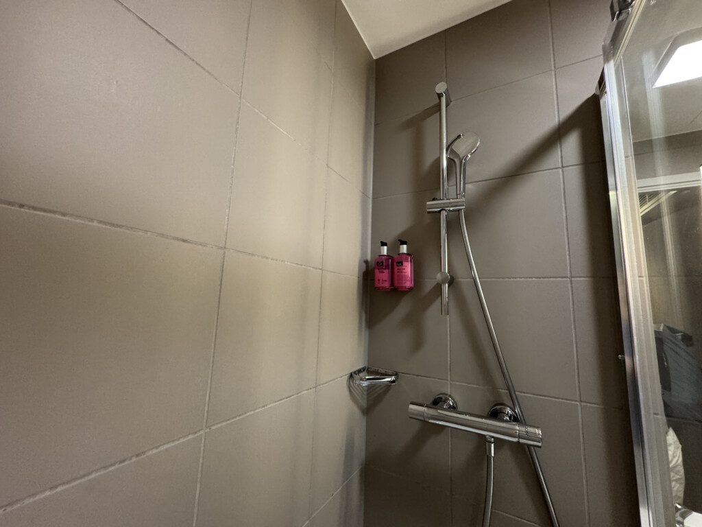 a shower with a shower head and shower head