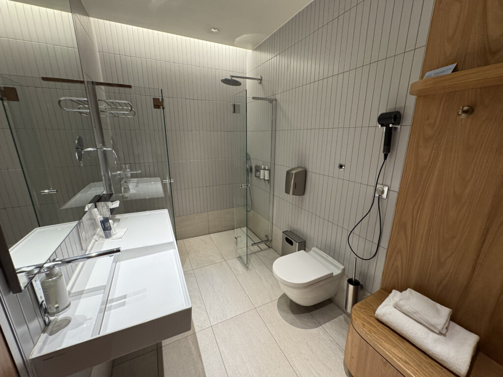 a bathroom with a glass shower and sink