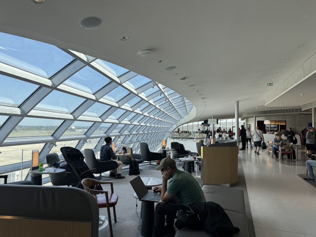 people sitting in a room with windows
