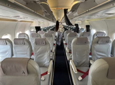 a person standing in the aisle of an airplane