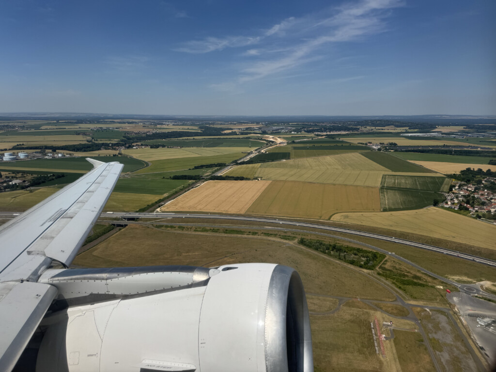 an airplane wing and a landscape