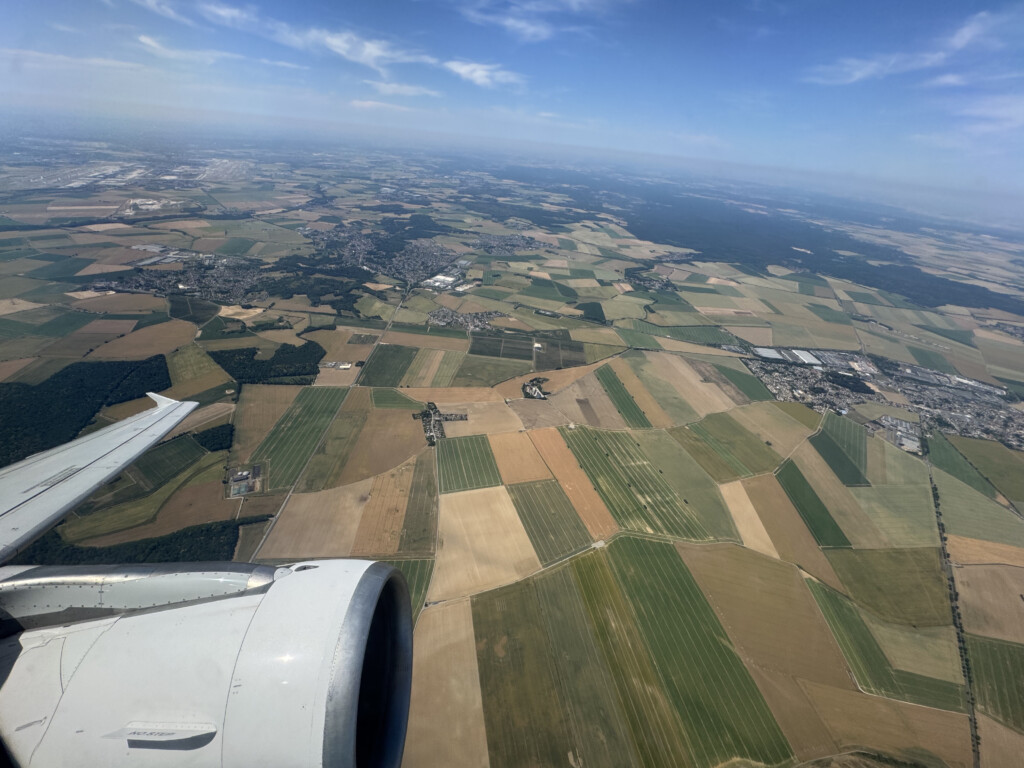 an airplane wing and a landscape