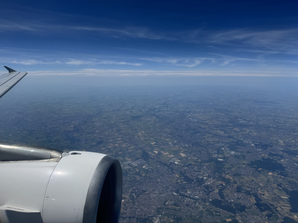 an airplane wing and a city below