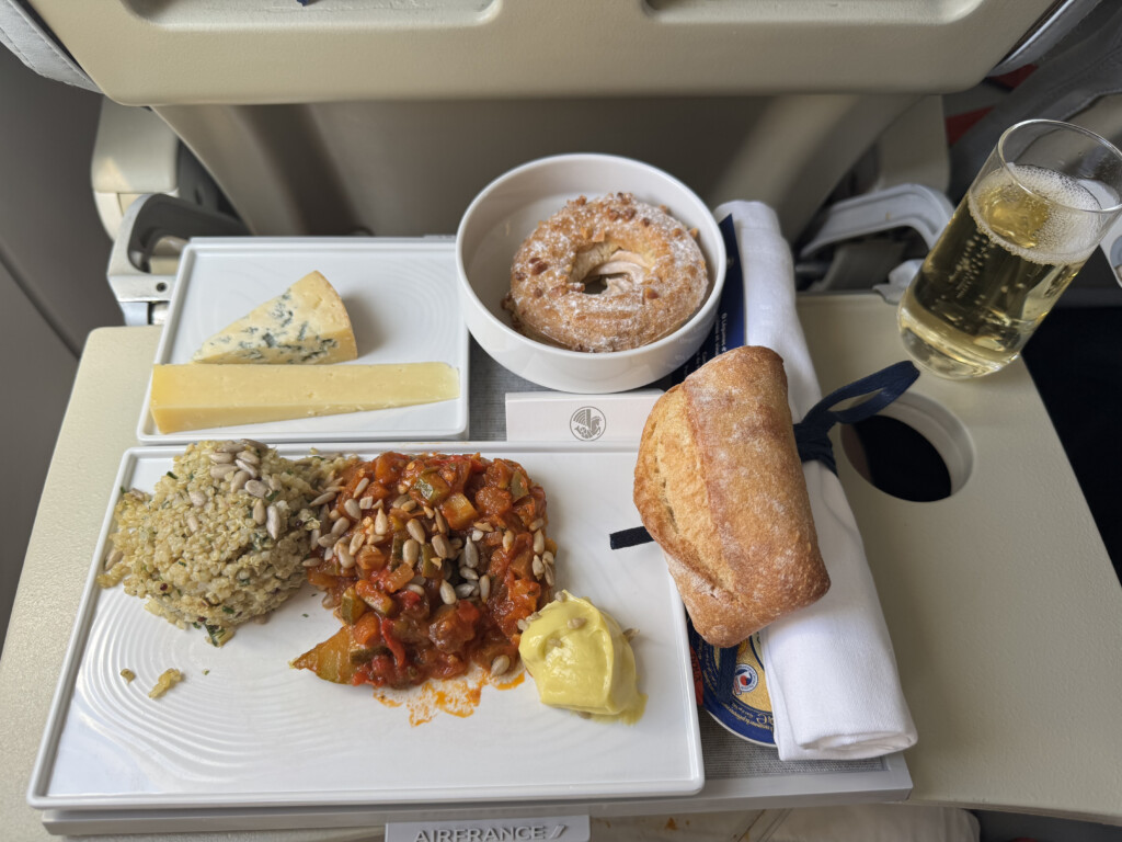food on a tray with a drink and a bagel