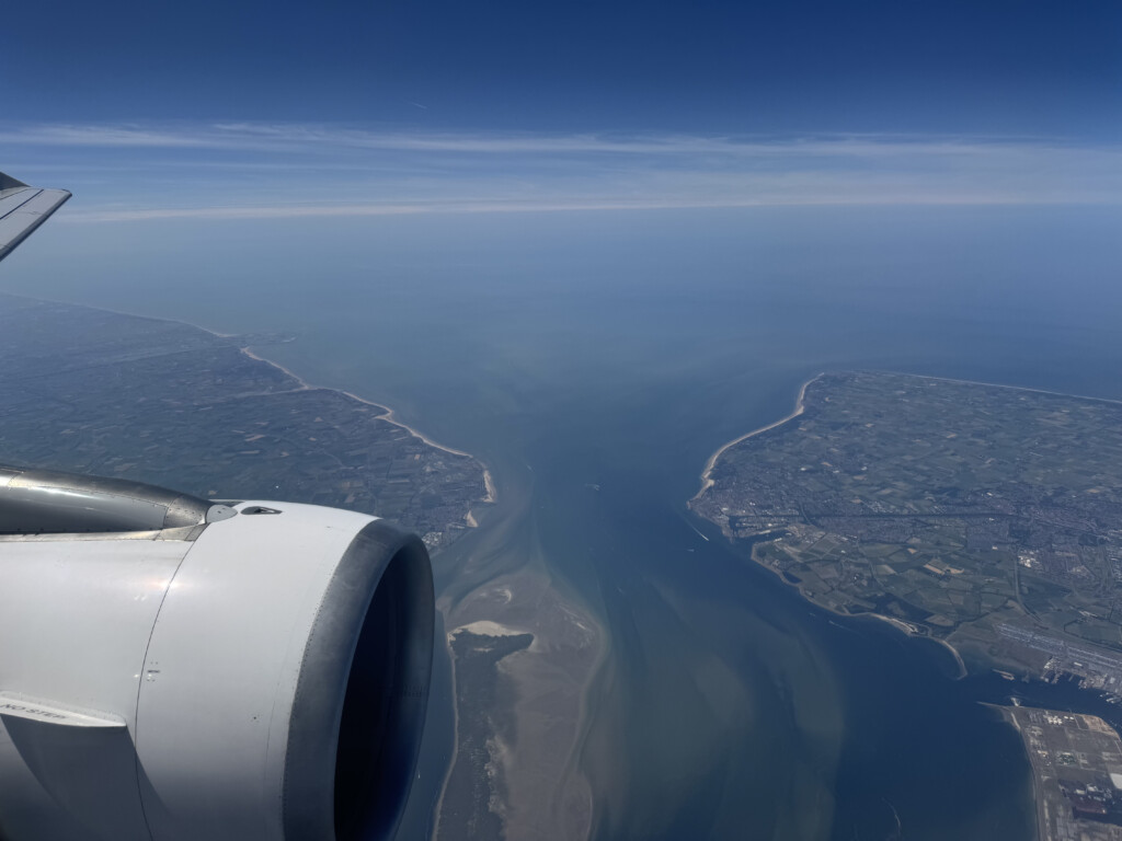 an airplane wing and a body of water