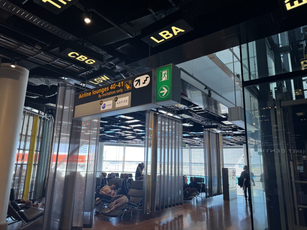 a group of people sitting in chairs in an airport