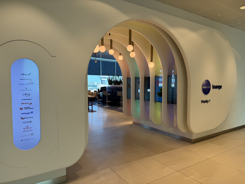 a white archway with lights and a sign
