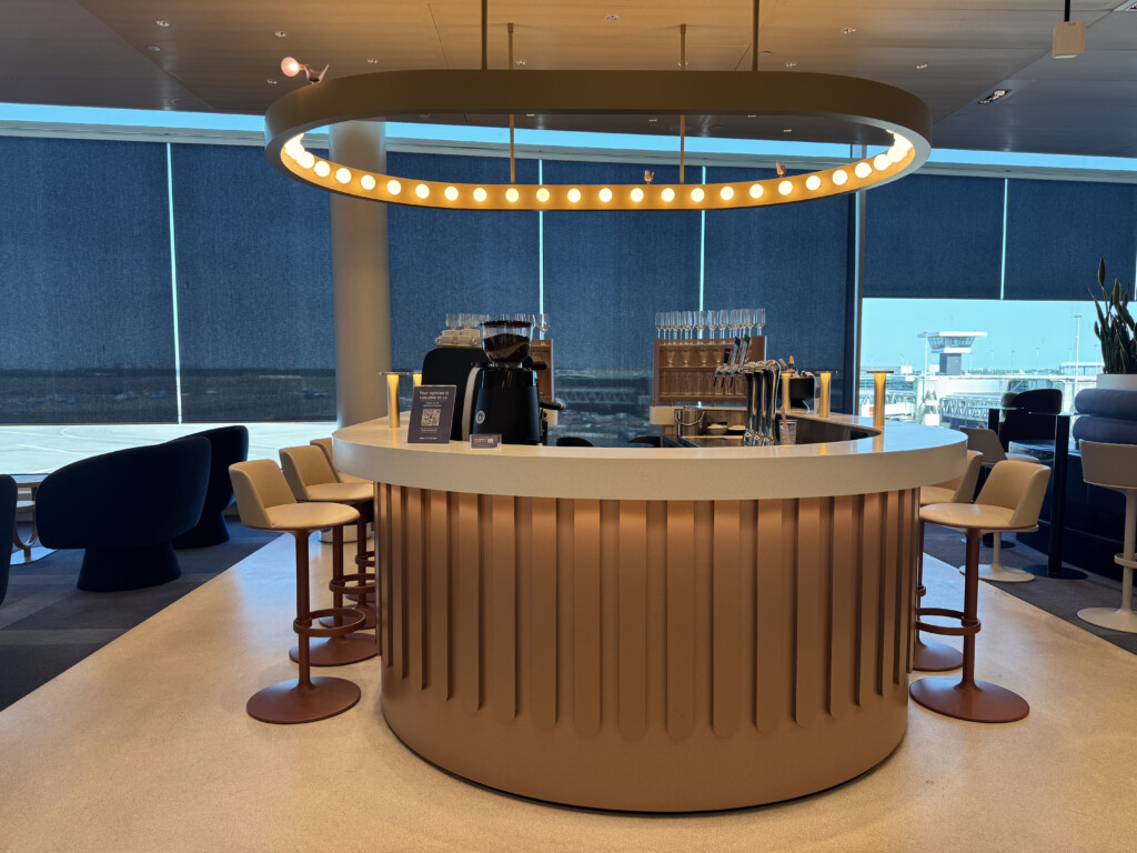 a bar with a round counter and chairs