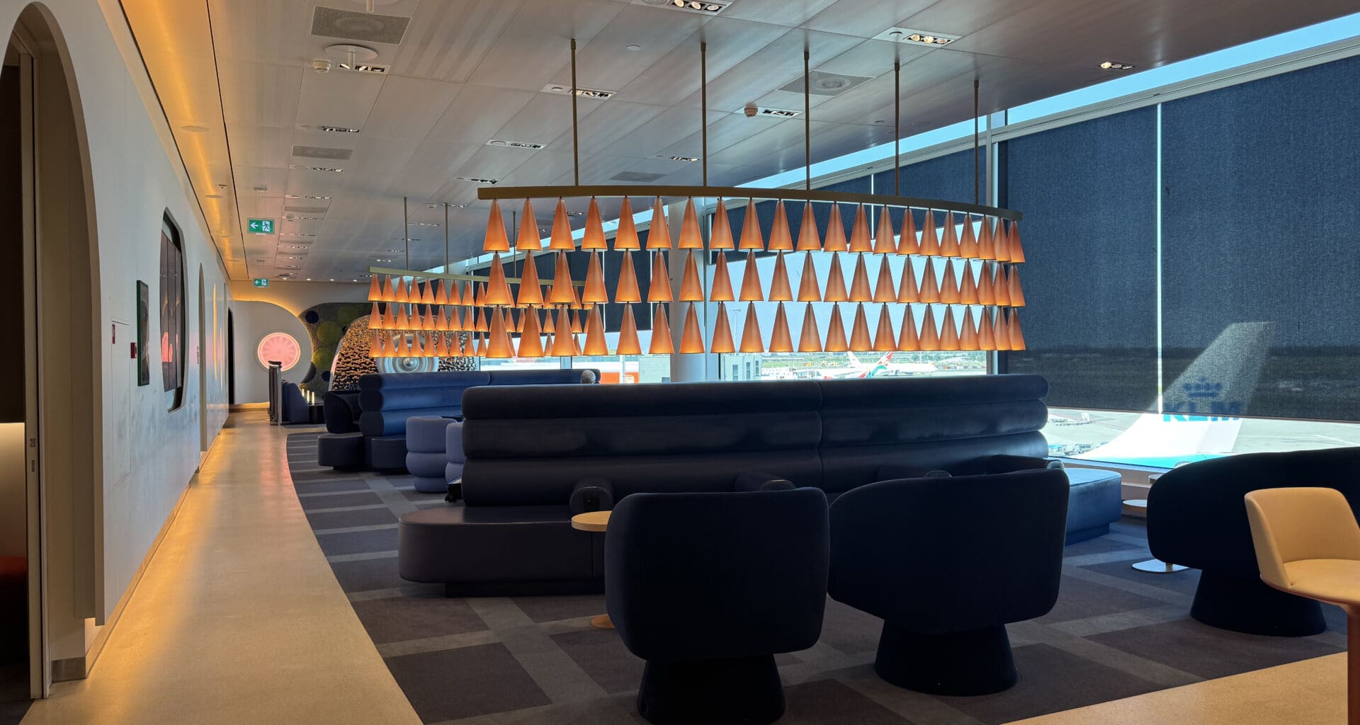 a room with a large chandelier and couches