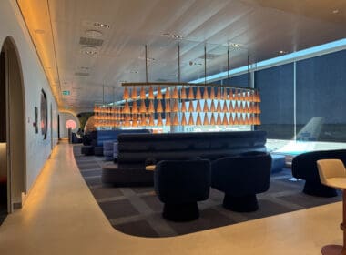 a room with a large chandelier and couches