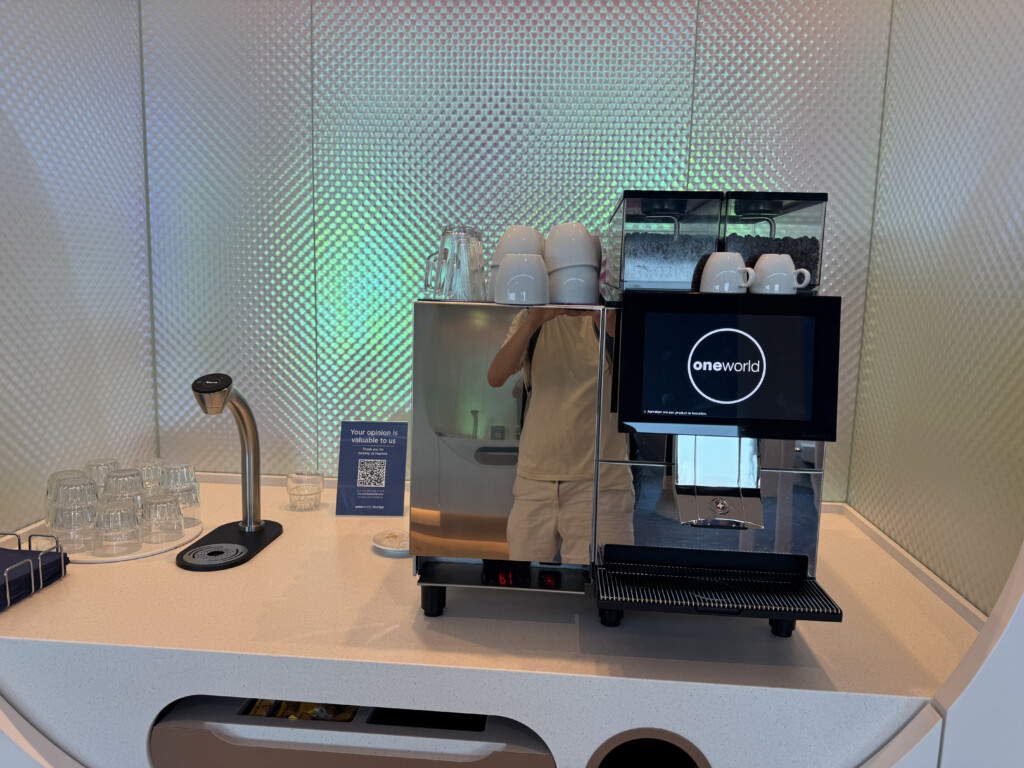 a coffee machine with a person behind it