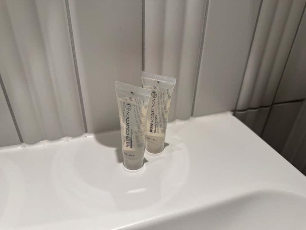 two small plastic tubes with white text on them