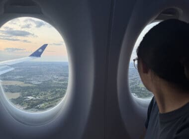 a woman looking out of an airplane window