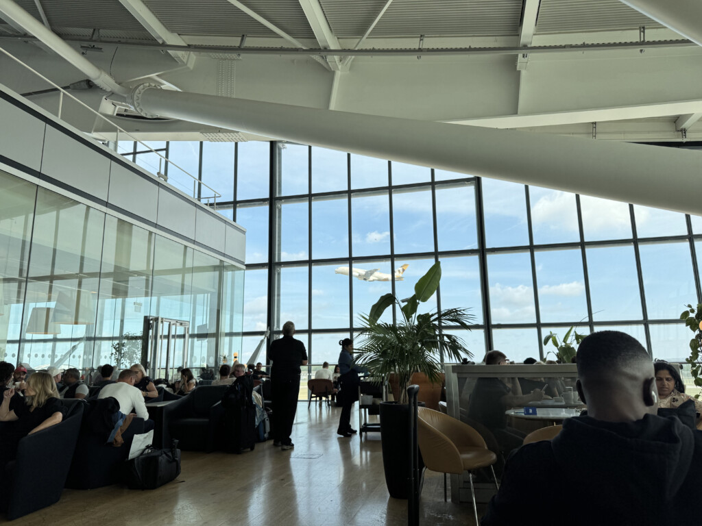 a group of people in a room with large windows