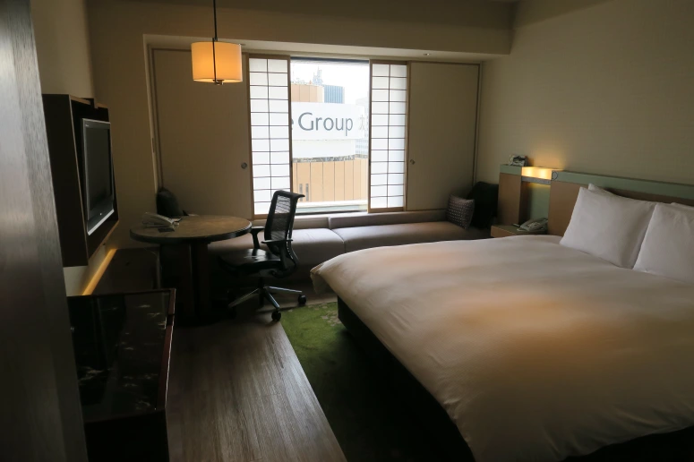 a room with a bed and a television