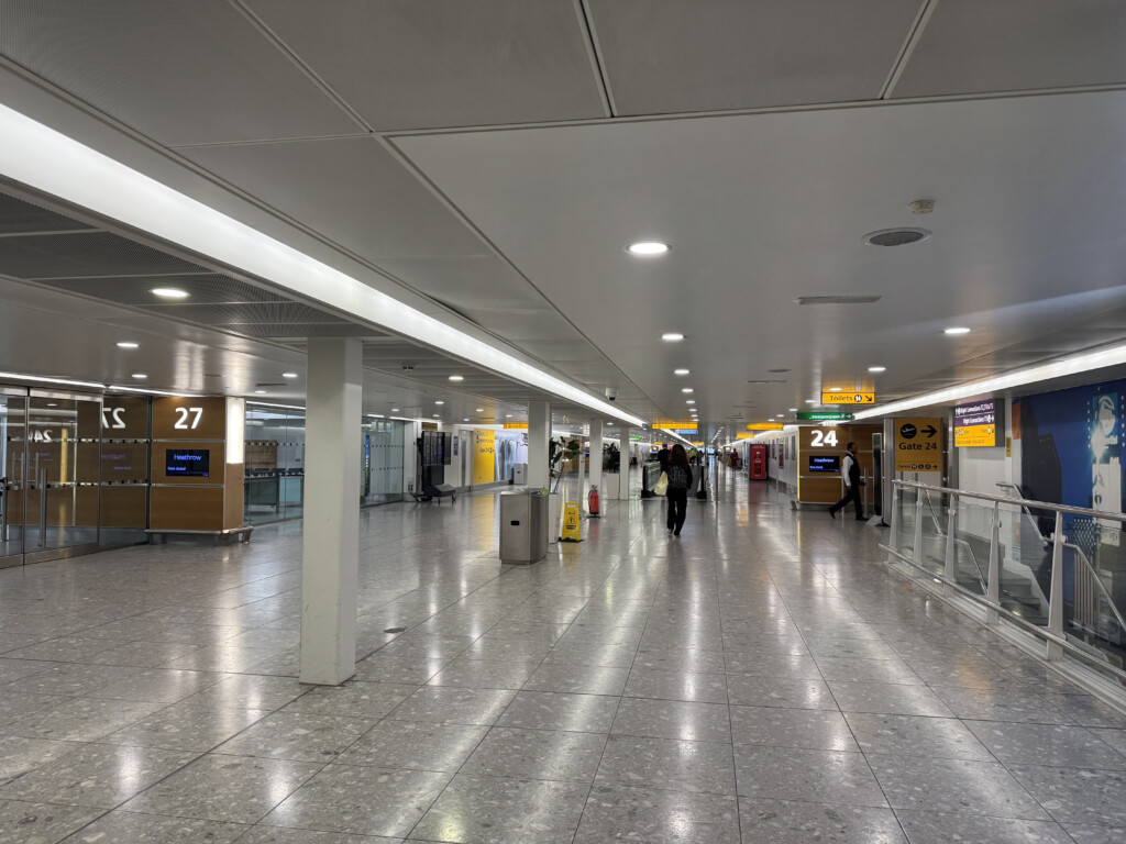 a large white hallway with people walking in it