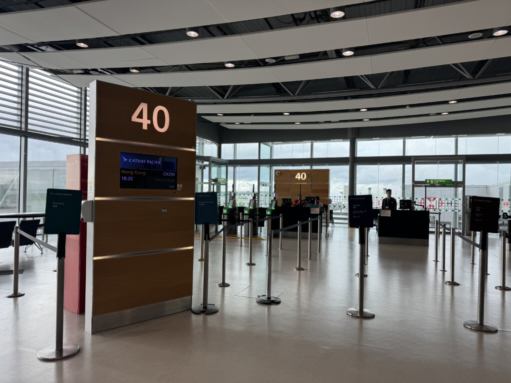 a large airport terminal with signs and people