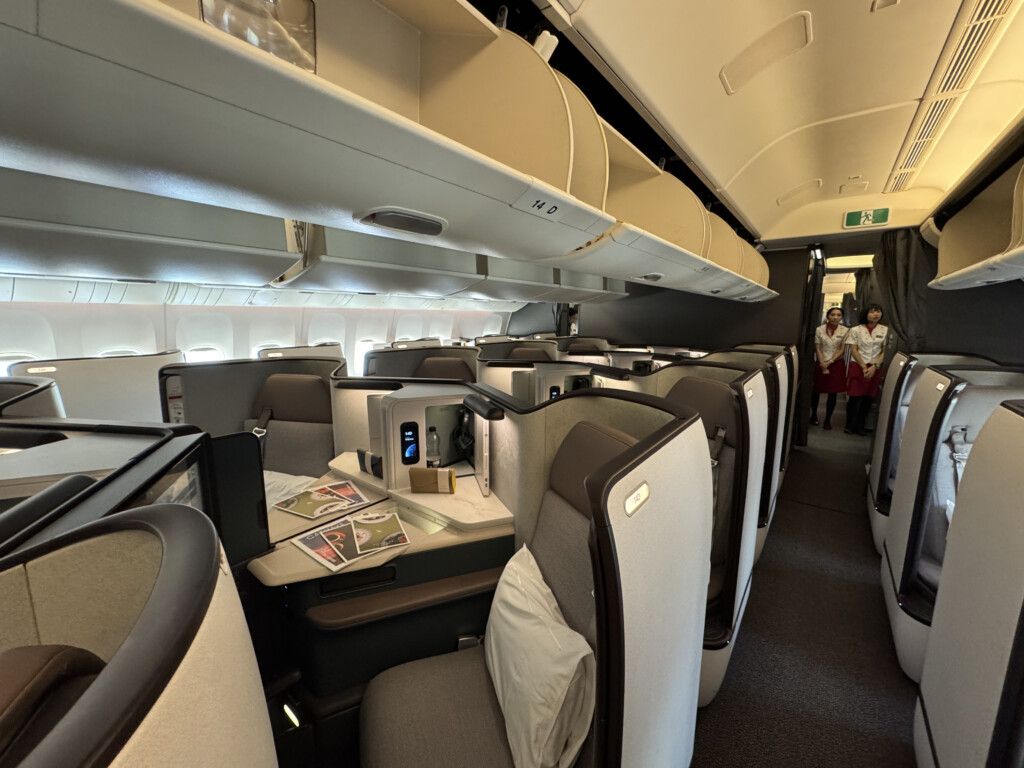 a inside of an airplane with chairs and tables
