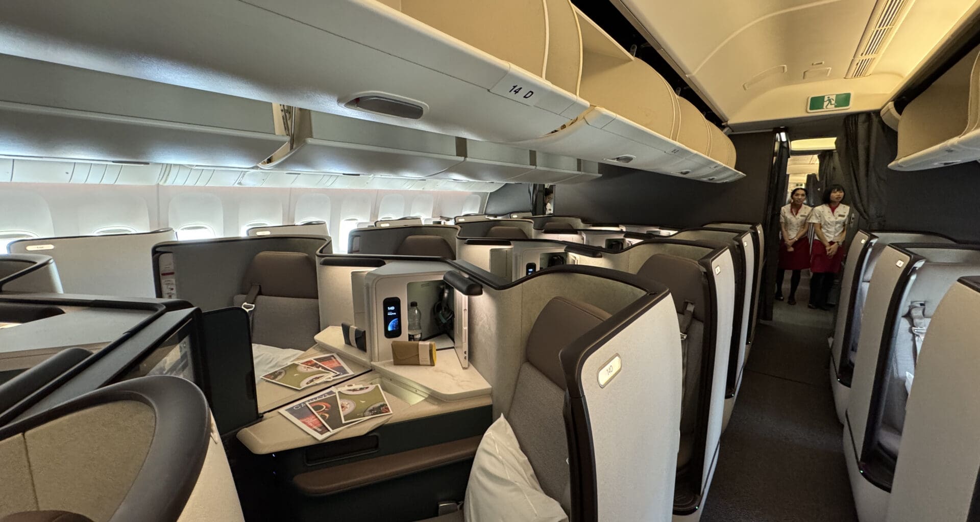 a inside of an airplane with chairs and tables