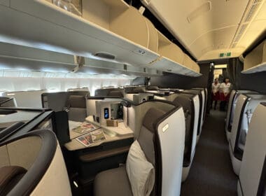 a inside of an airplane with chairs and tables