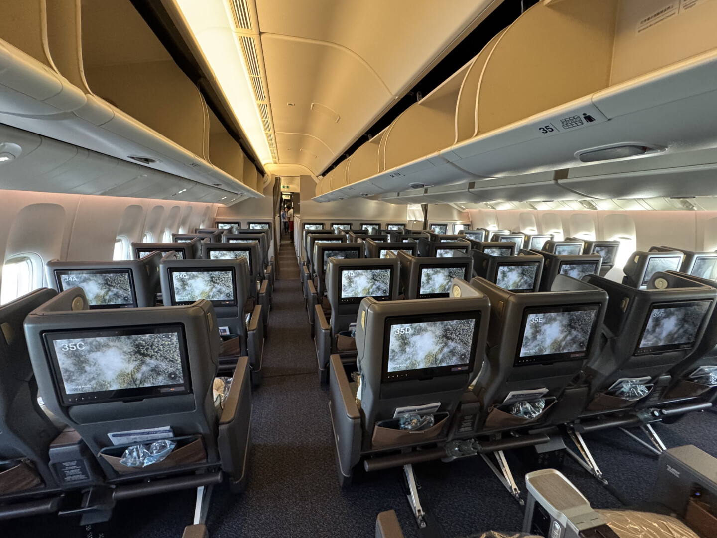 an airplane with rows of seats and monitors
