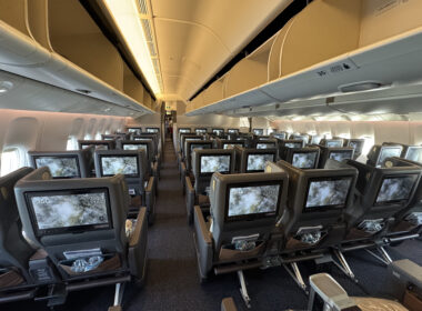 an airplane with rows of seats and monitors