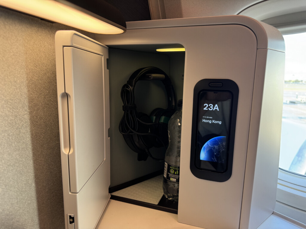 a small white box with a phone and headphones inside