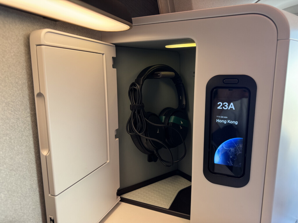 a phone and headphones in a small cabinet