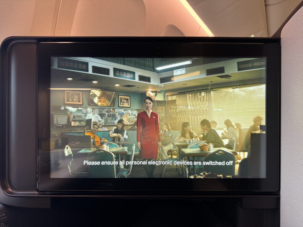 a screen with a picture of a woman in a red dress