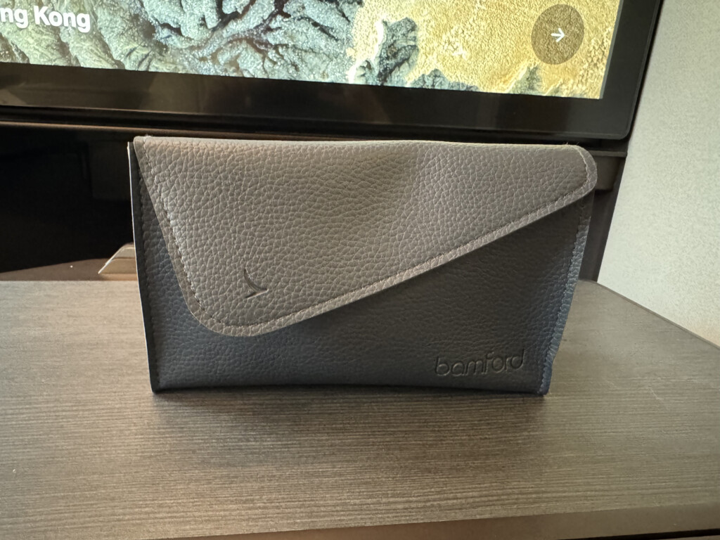 a grey and black purse on a table