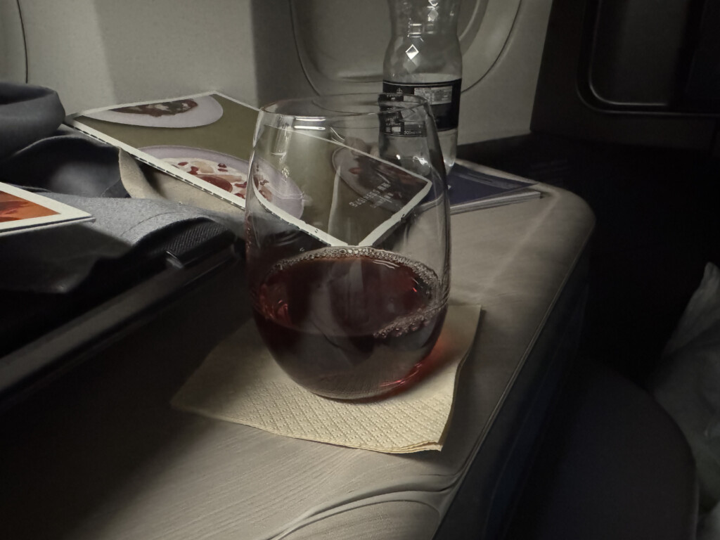 a glass of wine on a napkin on a table