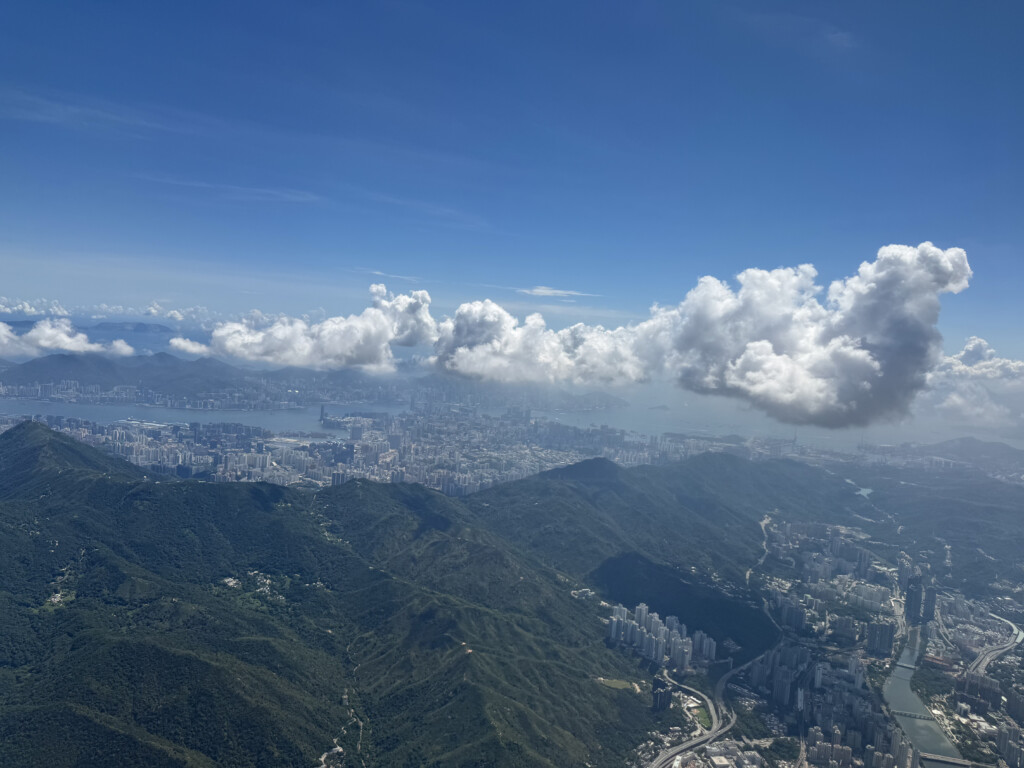 a city and mountains with clouds
