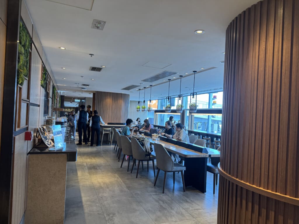 a group of people sitting at tables in a restaurant