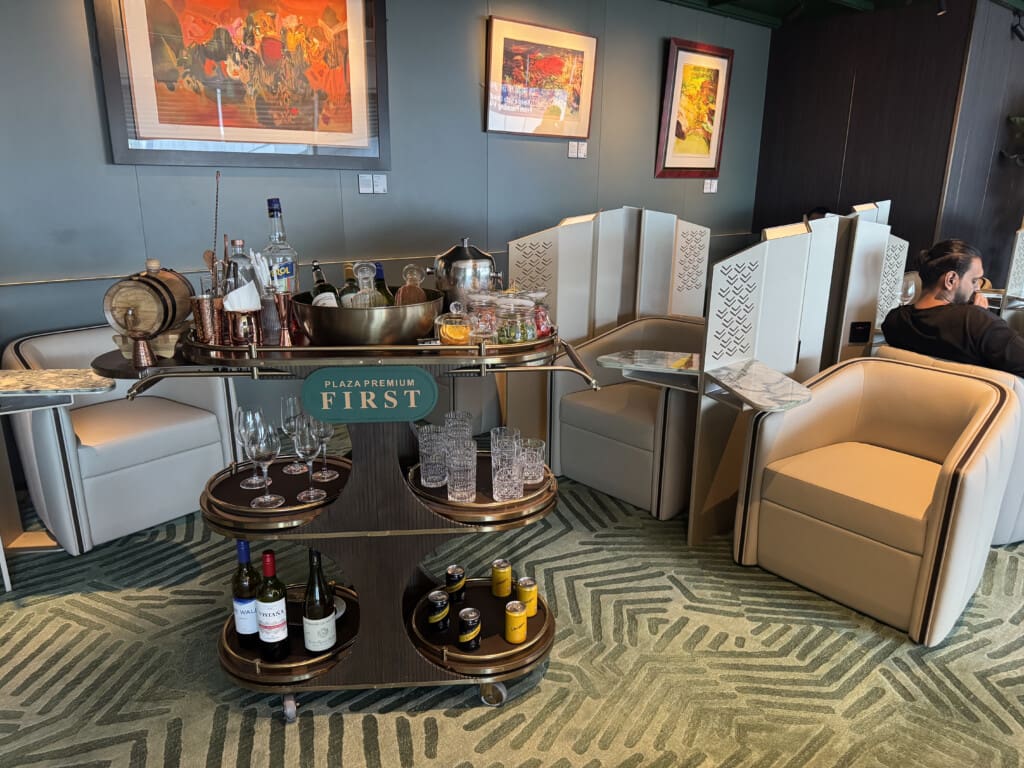 a bar cart with bottles and glasses on it