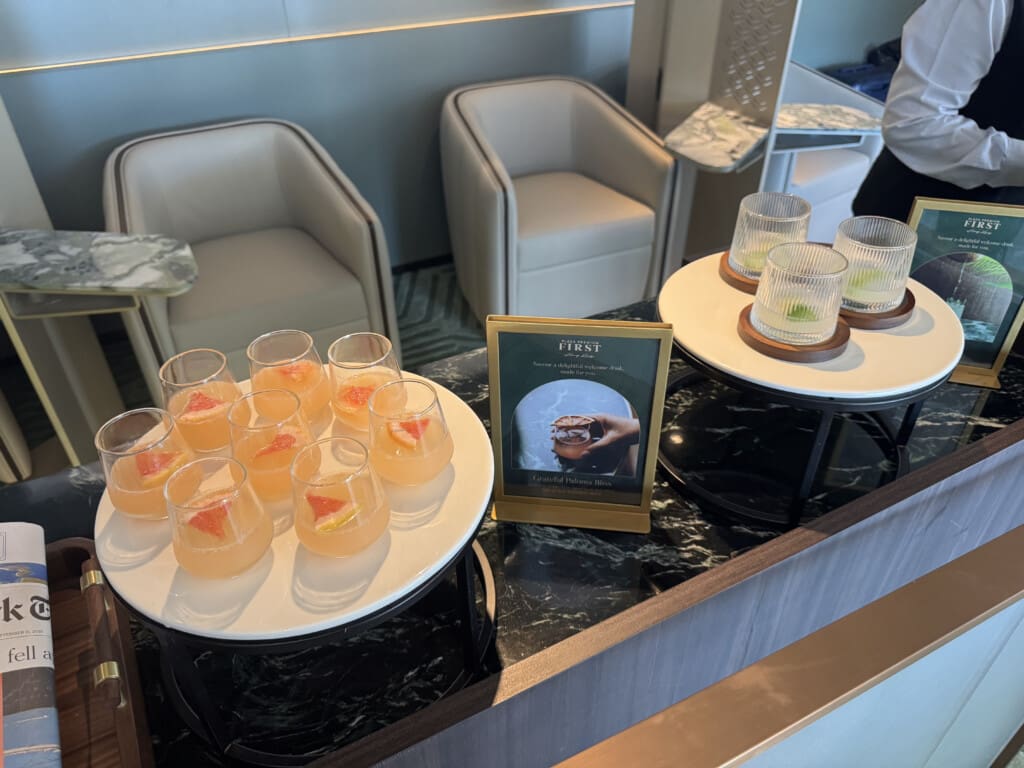 a table with glasses of liquid and glasses of orange liquid on it