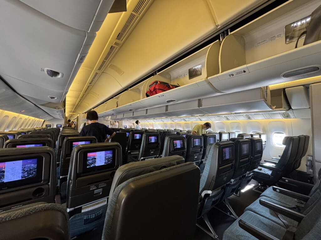an airplane with people sitting in the seats