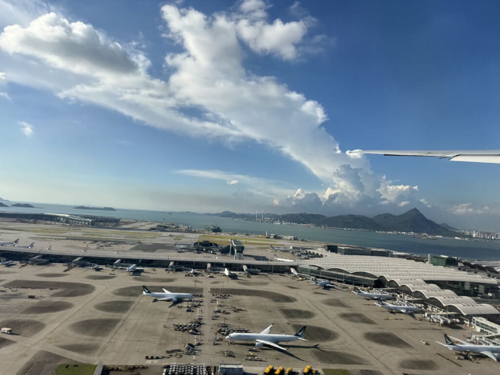 an aerial view of an airport with planes and a body of water