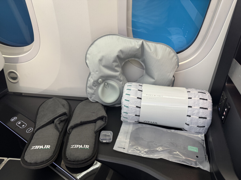 a group of slippers and travel items on a plane