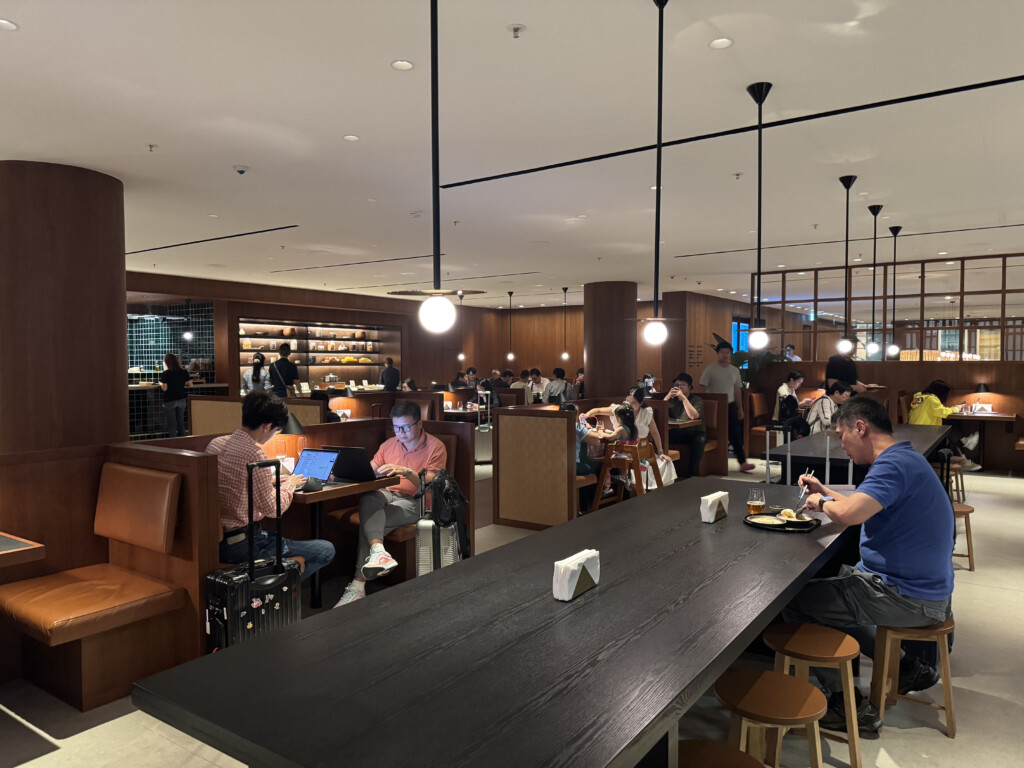 people sitting at tables in a restaurant