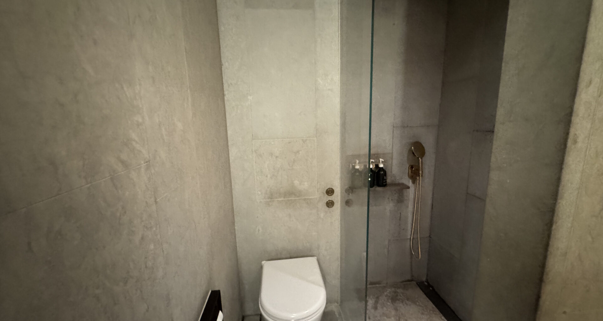 a bathroom with a glass shower door