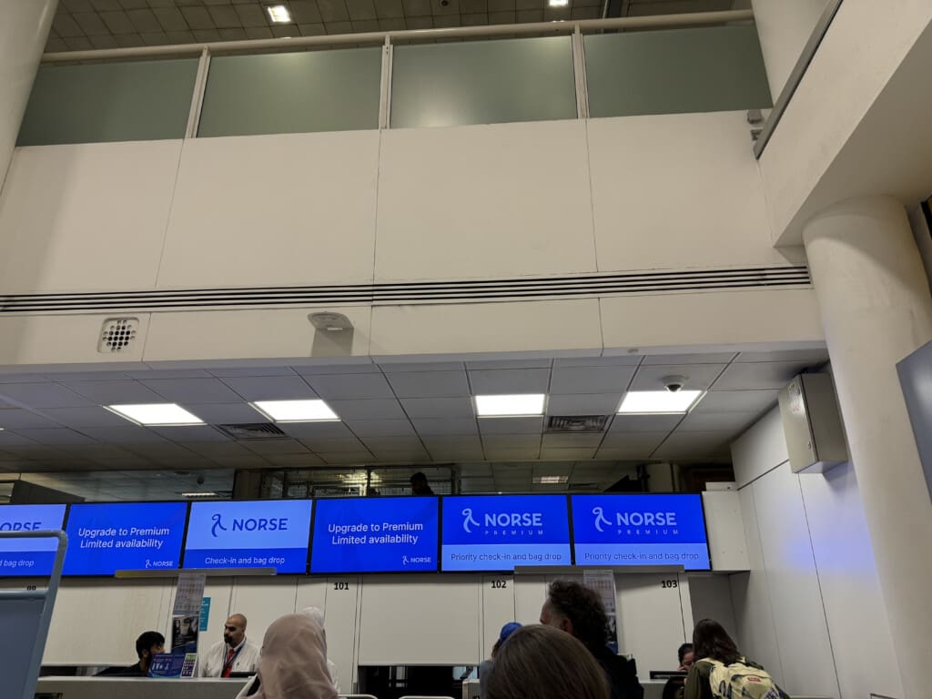 a group of people in a room with blue screens