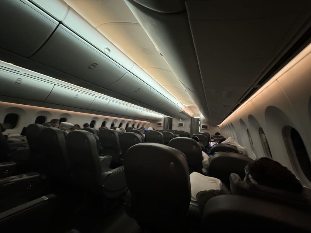 a plane with people sleeping on seats