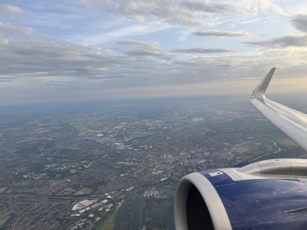 an airplane wing and a city